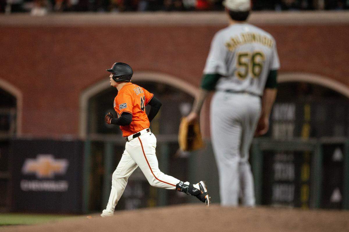 May 16, 2025; San Francisco, California, USA; Athletics pitcher Anthony Maldonado (56) San Francisco Giants first baseman Wilmer Flores (41) run out his solo home during the eighth inning at Oracle Park. Mandatory Credit: D. Ross Cameron-Imagn Images
