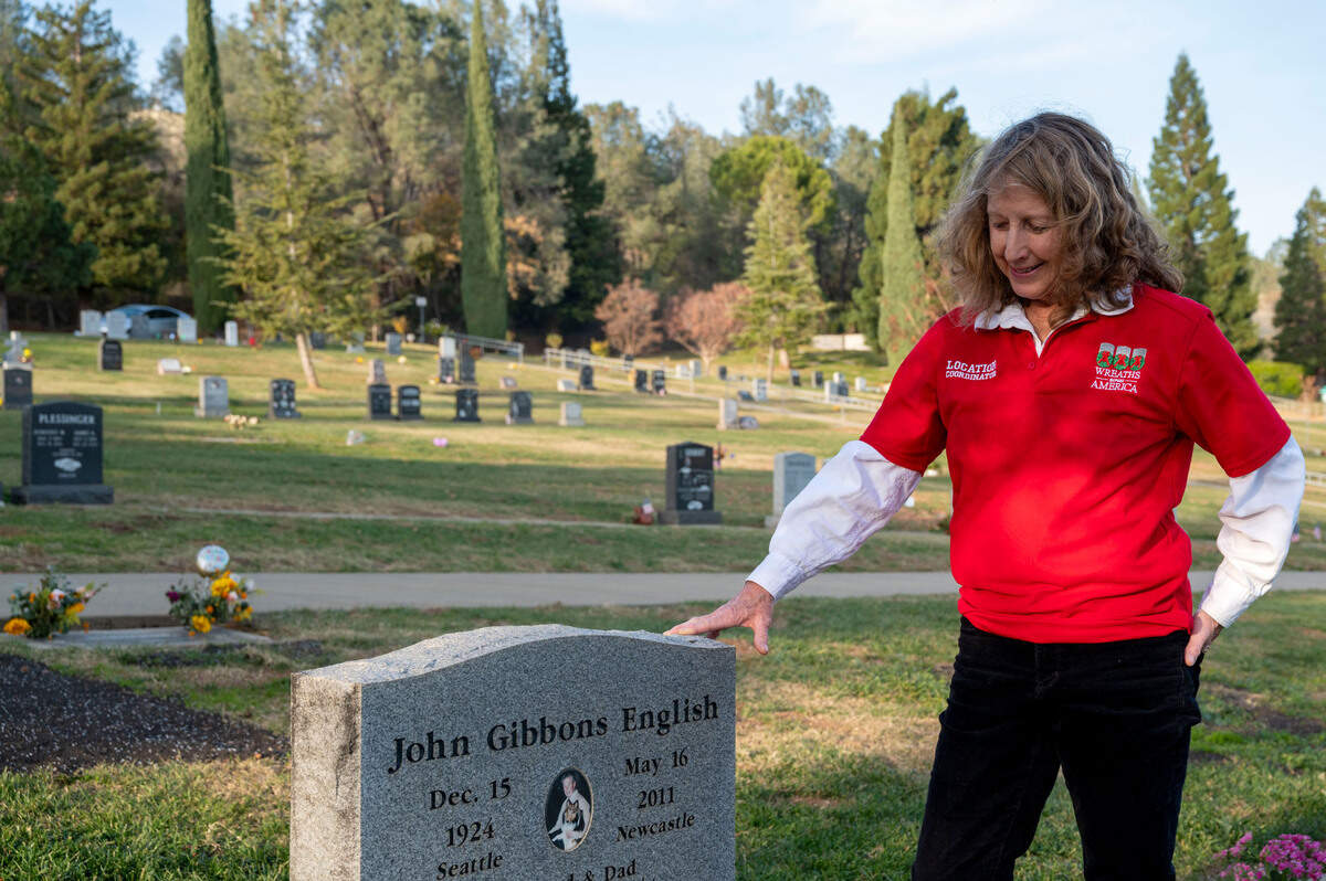 Joanne English, a location coordinator with Wreaths Across America, stands near her father’s grave at the Newcastle Cemetery on Wednesday. He is among 1,252 veterans buried at the Newcastle, Rocklin, Gold Hill and Ophir cemeteries in Placer County and English is hoping to place wreaths on all their headstones for a national day of remembrance on Dec. 17.