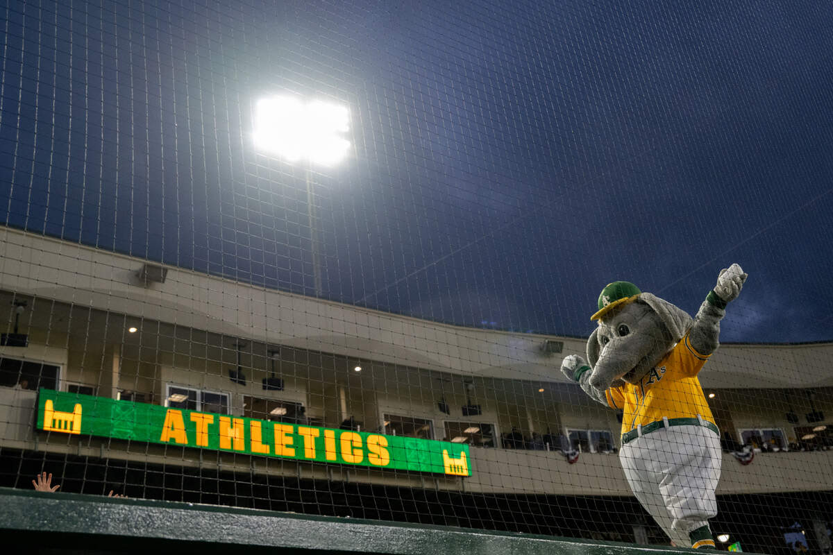 Athletics mascot Stomper walks across the dugout during the first Major League Baseball game at Sutter Health Park on Monday night/