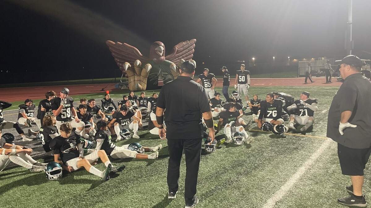 Liberty Ranch High School football coach Warren Schroeder talks to his team following a 49-18 victory over Bear River in the first round of the Sac-Joaquin Section playoffs.