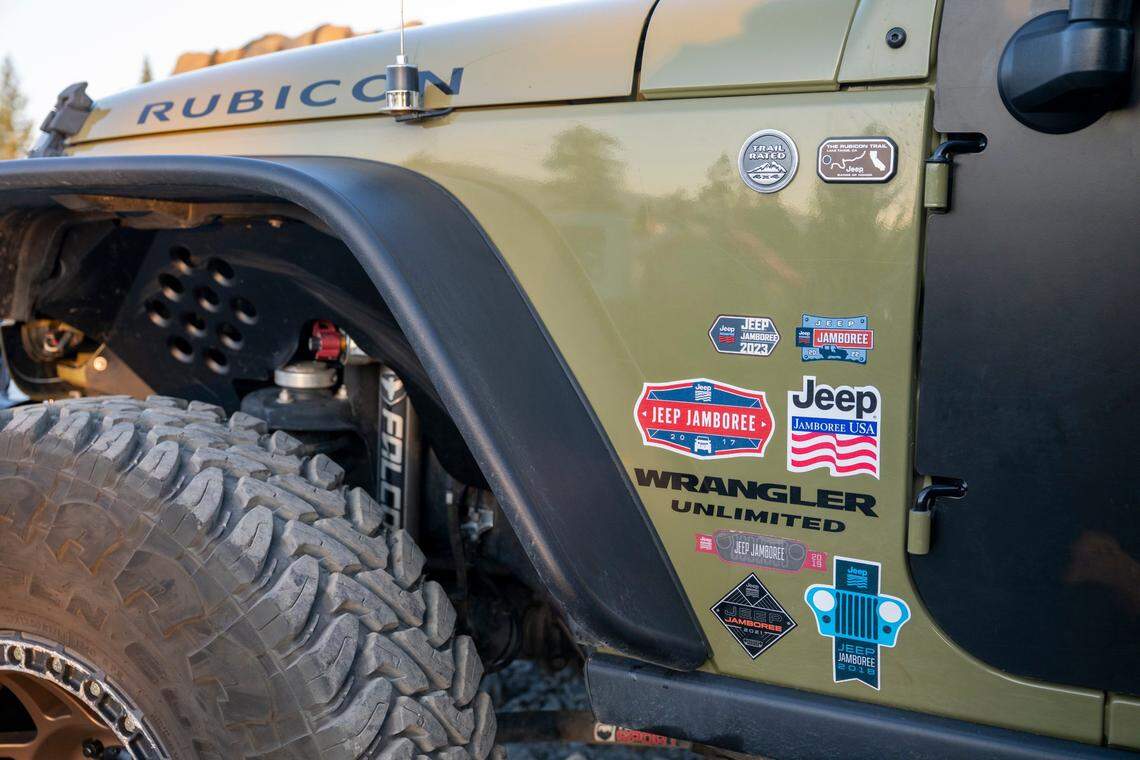 Jeep Jamboree stickers from years past decorate Justin Klotz’s Jeep Rubicon as he prepares to embark on the Rubicon Trail as a part of the 2025 Jamboree in El Dorado County on June 11.