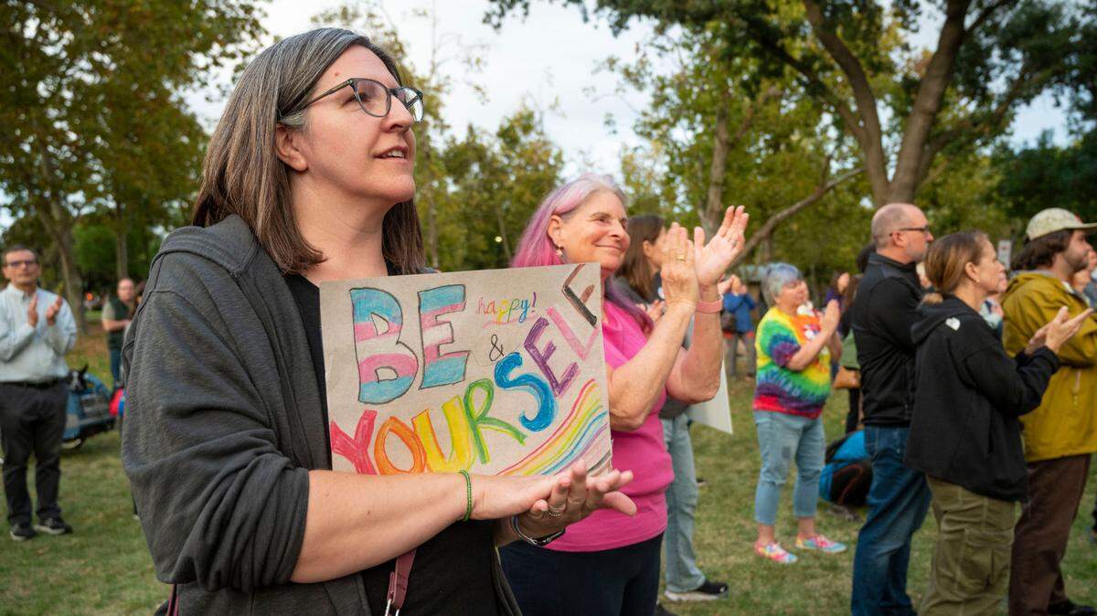Davis resident and parent, Nada Nakahara, left, stands in unity with others in support of gender-identity topics at the Yolo is for Everyone event in October, after bomb threats with anti-LGBTQ language were made at Davis-area schools and the city’s main library.