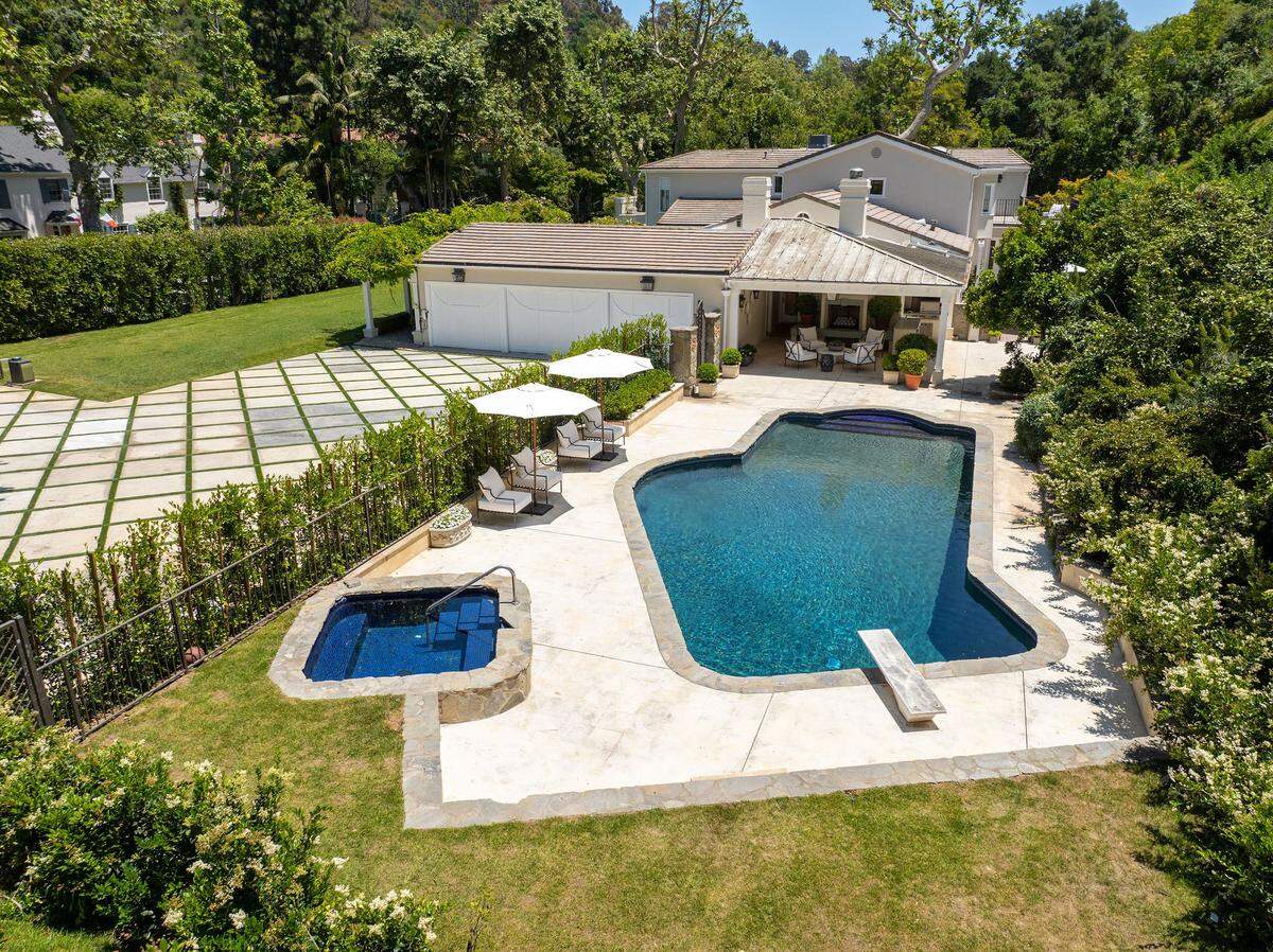 A pool punctuates the grounds that sprawl across nearly three acres.