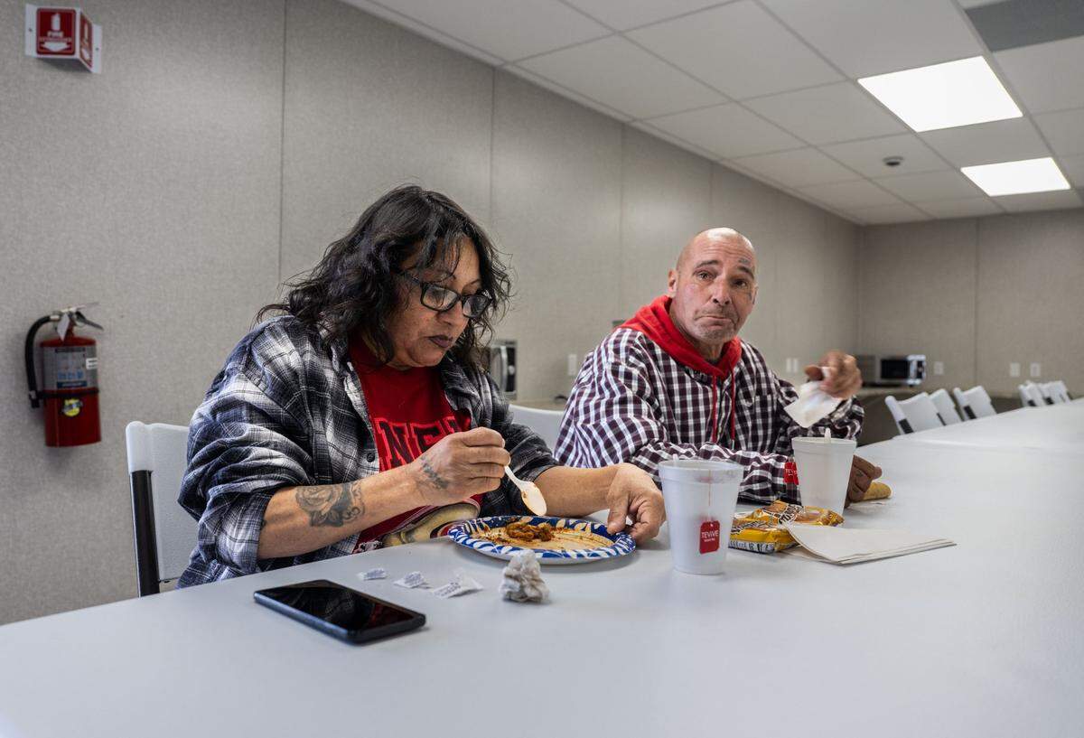 Natalia Sanchez and Bartholomew Keller have lunch Wednesday in the dinning room at the new Stockton Boulevard Safe Stay Community, a county facility to help house the homeless that opened last month.