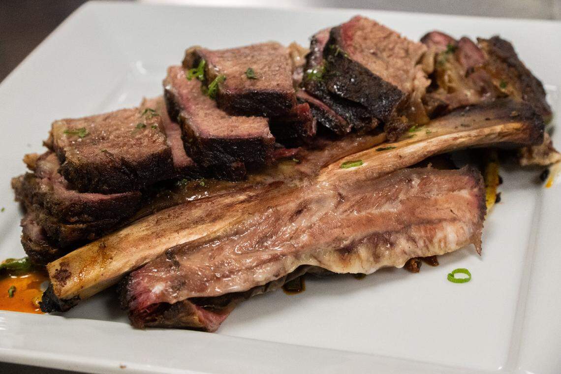 Smoked beef rib sits on display during this year’s Tower Bridge Dinner menu preview at the Central Kitchen in Sacramento on Monday. This fifth course dish from Beast + Bounty executive chef Brock Macdonald is served with spicy pole beans, sticky rice, a Vietnamese herb salad and grilled peaches.