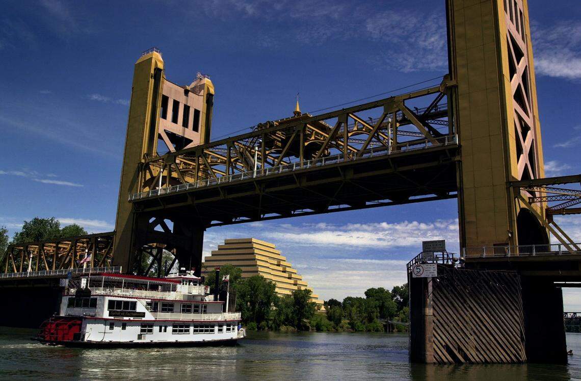 The Spirit of Sacramento, a paddle wheel boat replica, passes through the raised Tower Bridge on its way toward Old Sacramento in 2001.
