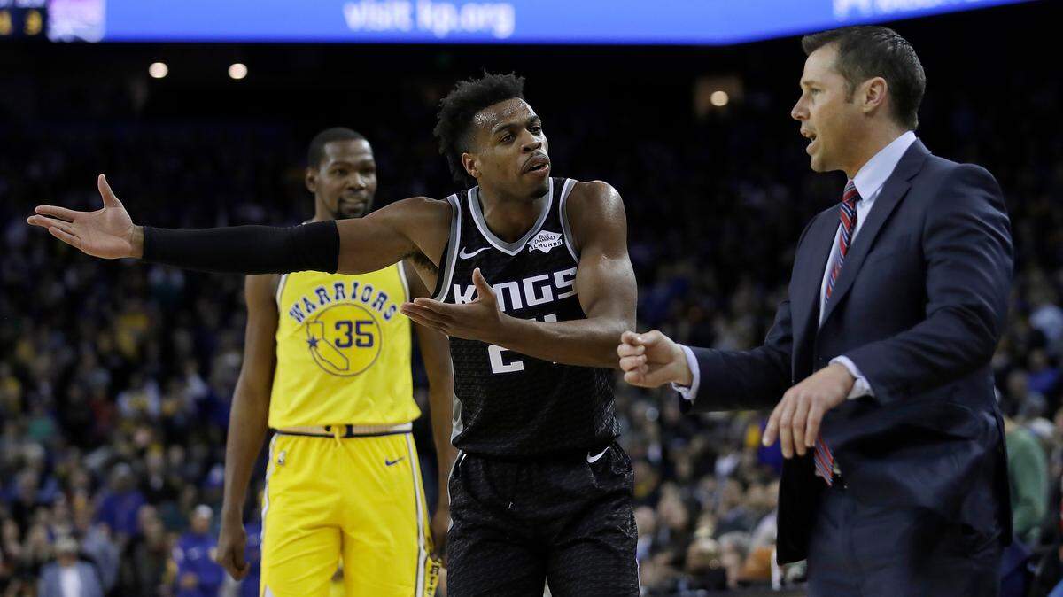 With Warriors star Kevin Durant (35) watching, Kings guard Buddy Hield, center, gestures to coach Dave Joerger, right, during their heated conversation in the final minute of Thursday night’s game in Oakland.