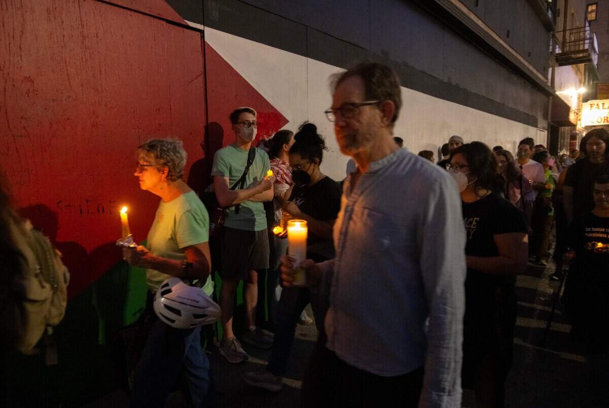 Supporters participate in a candlelight vigil by the Sacramento Regional Coalition for Palestinian Rights opposing the conflict in Gaza on Monday in Sacramento. The upporters held a rally in Caesar Chavez Park and then walked to a Palestine national flag mural to place candles.
