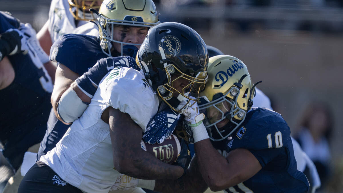 UC Davis Aggies defensive back Jayden Stanley (10) tackles Sacramento State Hornets running back Rodney Hammond Jr. (2) in the first half in the Causeway Classic on Saturday, Nov. 22, 2025 in Davis.