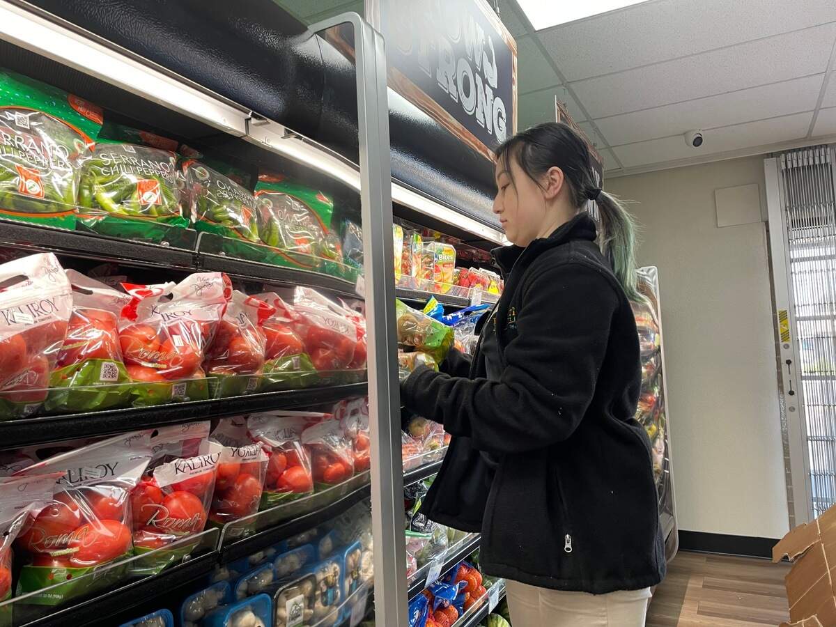 Susan Flores, who’s worked for Prime TIme Nutrition for five years, restocks the store’s produce shelves on Thursday, June 15, 2023. The grocery store chain offers fresh produce at affordable prices and encourages customers on food support programs, like WIC, SNAP and EBT, to shop in its stores. The Northgate Blvd location opened in early May.