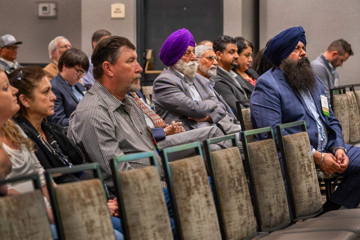 Sutter County Supervisor Karm Bains, at right, a fourth-generation peach farmer, listens to a presentation at the California Canning Peach Association’s annual conference in Sacramento on Feb. 4. Instead of a celebration, the conference was more like a funeral after the closure of Del Monte cannery in Modesto. “Nobody wins in a situation like this. We’re all losing,” Bains said. 