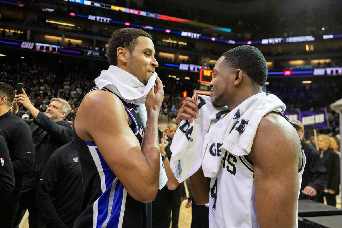 Sacramento Kings forward Keegan Murray (13) and San Antonio Spurs guard De’Aaron Fox (4) talk following the Kings’ 127-109 victory on Friday. 