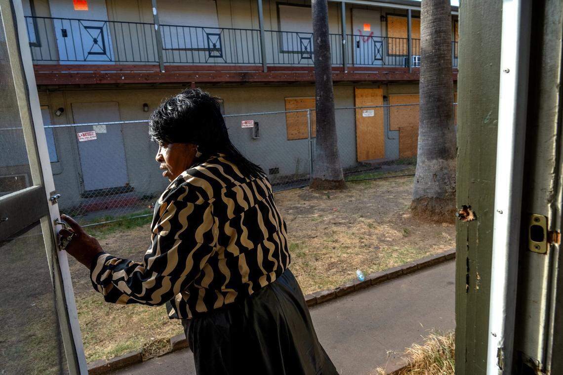 Jacqueline Saffo, 71, stands in the doorway at the Palms Apartments in Arden Arcade on Oct. 25 where she’s lived for six years. Last year, a fire destroyed one of two buildings in the complex and she lost everything. She moved to another unit with her family and dogs but says the living conditions are unhealthy and not safe.