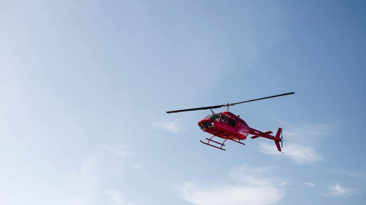 Three girls were rescued by helicopter from a raging stream in Hawaii, officials said.