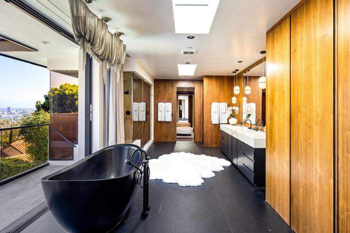 The primary suite in the Los Angeles estate is elegant, cool and seductive, with walls of glass opening to city views, two plush walk-in closets and a jaw-dropping bathroom.