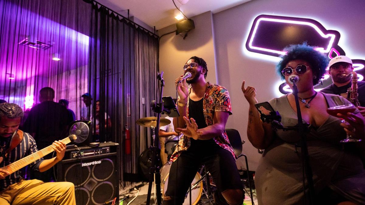 Julian Cunningham, center, sings alongside fellow vocalist Alicia Huff, right, while performing with a band at Tiger Bar and Restaurant on a Saturday, July 24, 2021, in downtown Sacramento.