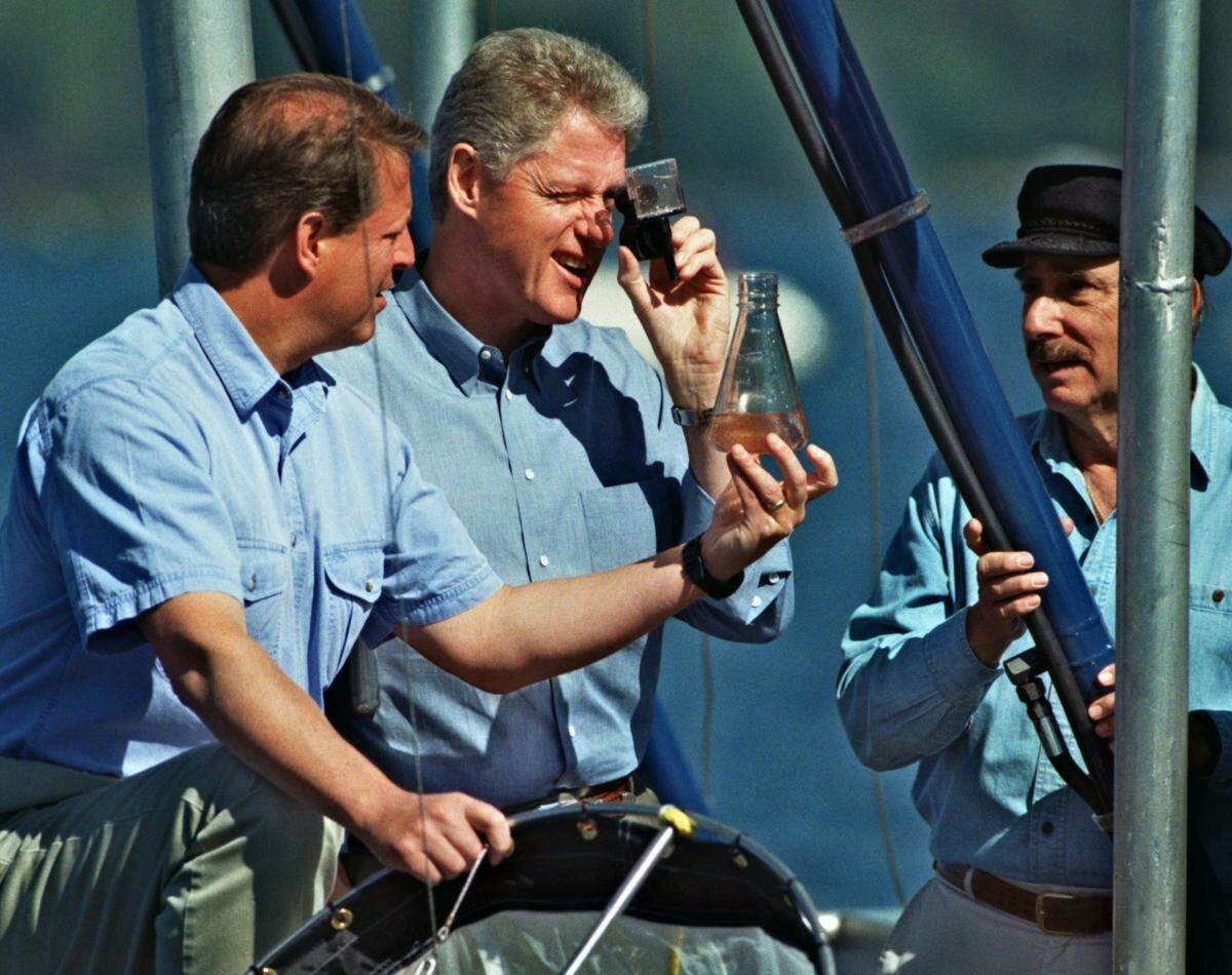 President Bill Clinton, center and Vice President Al Gore, left, observe tiny organisms from the waters of Lake Tahoe during a two-day environmental summit meeting to assess preserving the Lake Tahoe Basin from pollution. Conducting the lake tour is UC Davis professor Charles Goldman, right.