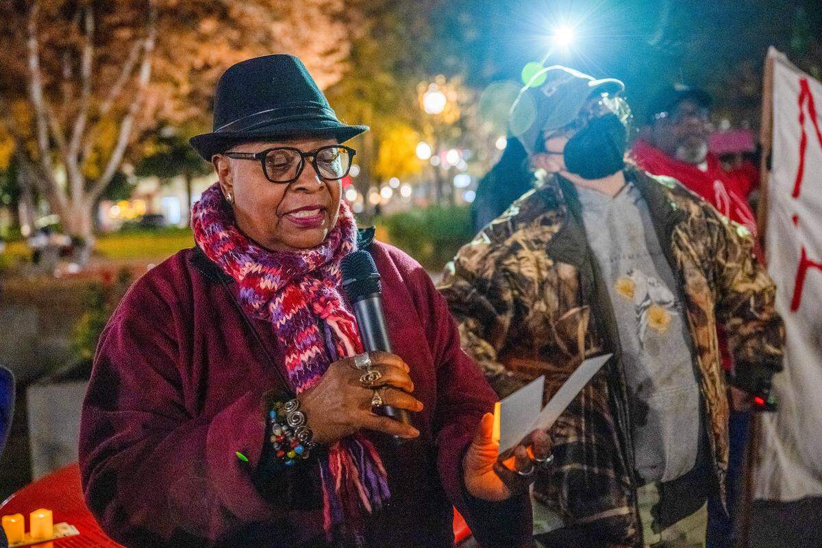 Faye Wilson Kennedy of the Sacramento Poor People’s Campaign reads the names of some of the 175 people the Sacramento County Coroner's Office identified as having died on the streets in the county in 2025 during a vigil to mark the deaths Sunday at Cesar E. Chavez Plaza in Sacramento. Niki Jones of the Sacramento Regional Coalition to End Homelessness, who helped organize the event, stands at right.