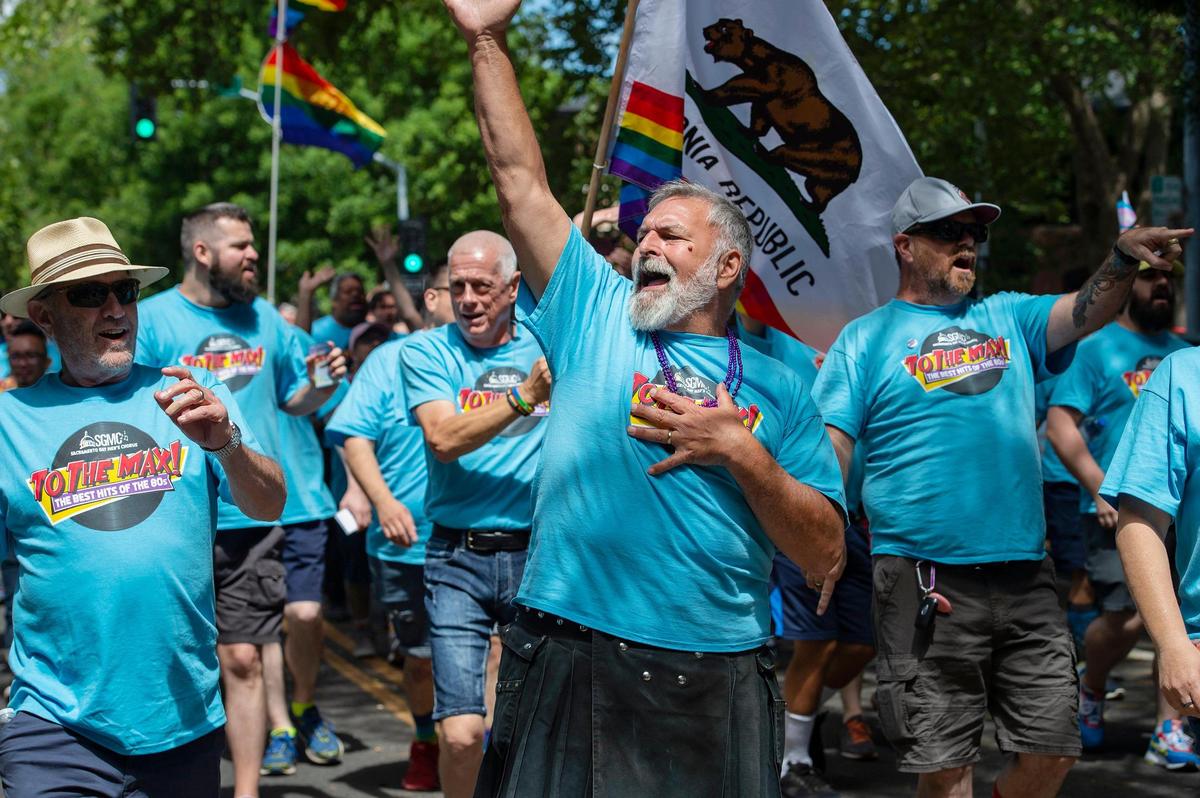 Ray Coshow, center, of Sacramento, sings with the Sacramento Gay Men’s Chorus at the Sacramento Pride march Sunday in downtown Sacramento. The event returned after a two-year COVID-19 hiatus.