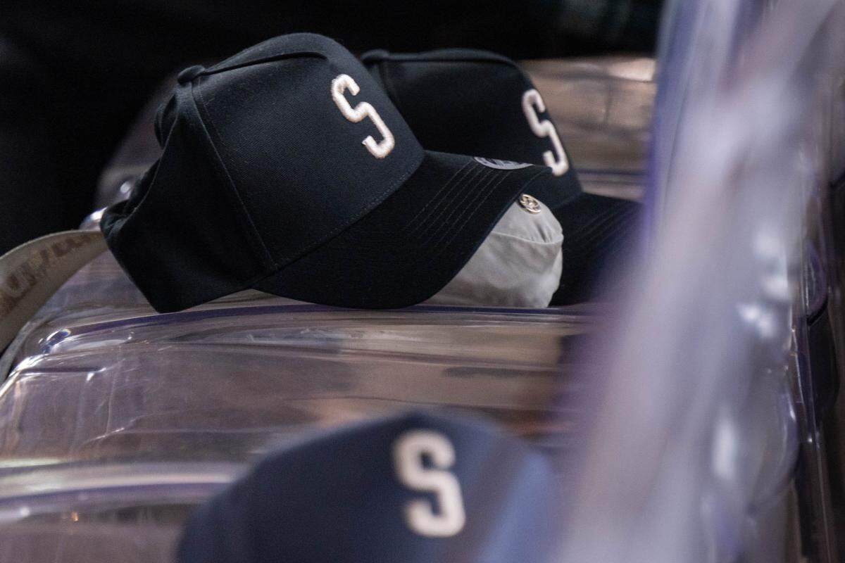Baseball-style caps with the letter “S” for Sacramento sit on display as Greater Sacramento regional leaders announce the region’s bid to secure a Major League Baseball expansion team during a press conference at The Barn on Thursday, May 28, 2026, in West Sacramento.