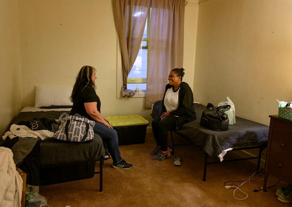 Anna Darzins, left, care coordinations manager with Volunteers of America visits with resident Dionne Small, 50, in her room at the Capitol Park Shelter on Friday, November 15, 2019, in Sacramento. Small was homeless for seven years and slept outside the Sacramento courthouse.