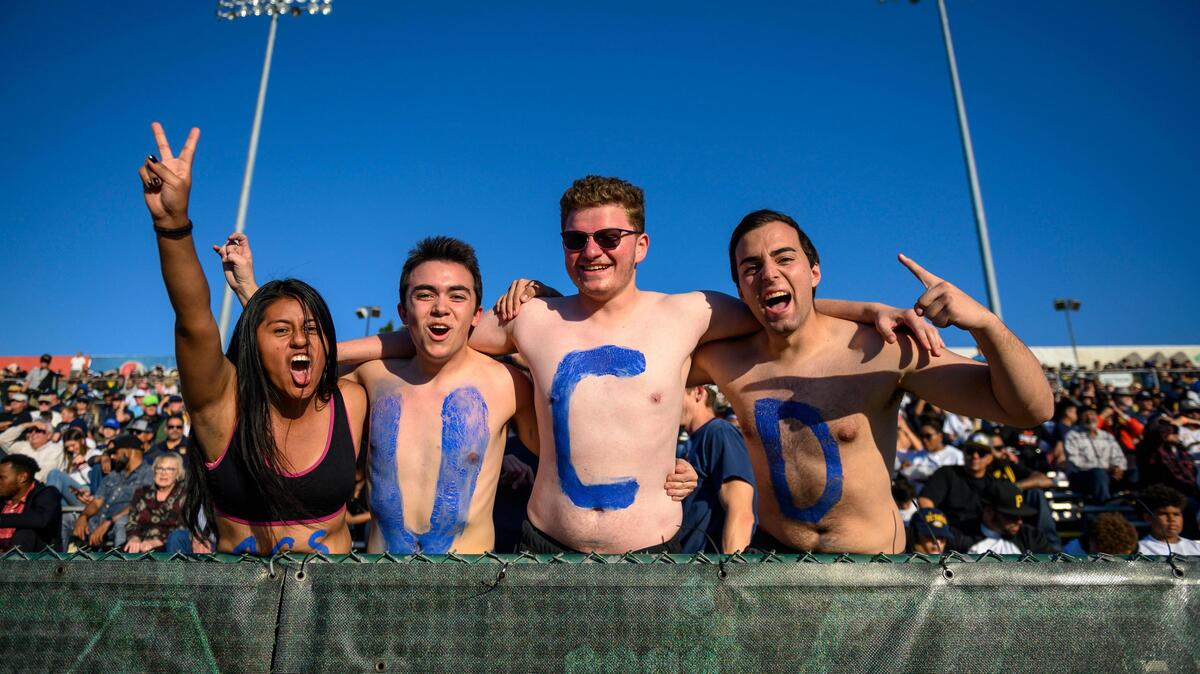 UC Davis senior Lucero Vasquez, sophomore Nik Wylie, sophomore Josh Siegel and sophomore Alex Householder cheer on the UC Davis Aggies Saturday, Nov. 23, 2019, during the 66th Causeway Classic at Hornet Stadium.