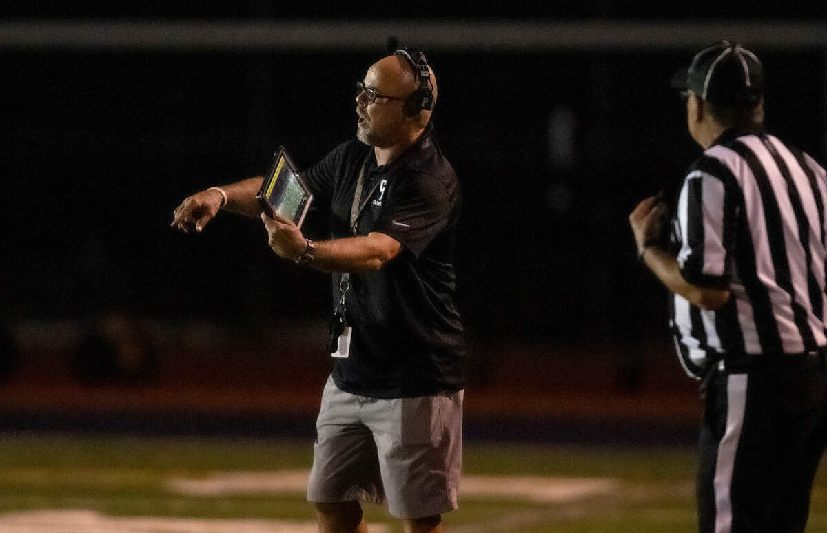 Casa Roble Rams coach Chris Horner shows an image of the game on his tablet to a referee as he disputes the spot after a Pioneer Patriots punt in the second quarter on Friday.