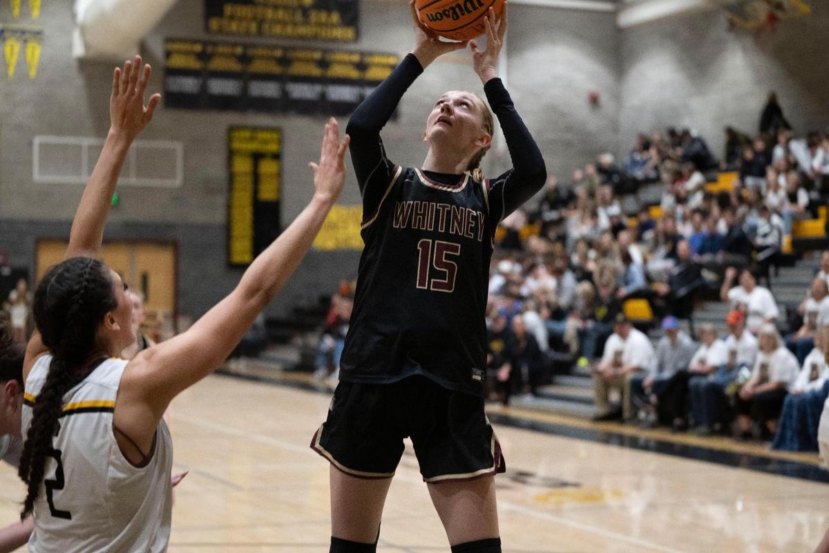 Whitney High School’s Harper Peterson, right, takes a shot in a girls basketball game Del Oro High School in Loomis on Friday.