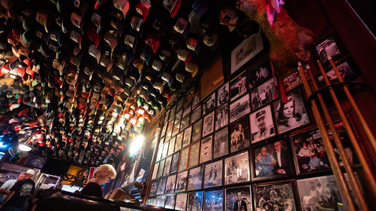 Hats hang on the ceiling and celebrity photos cover a wall at Giusti’s restaurant and bar in Walnut Grove on the Sacramento-San Joaquin Delta on Friday, July 23, 2021.