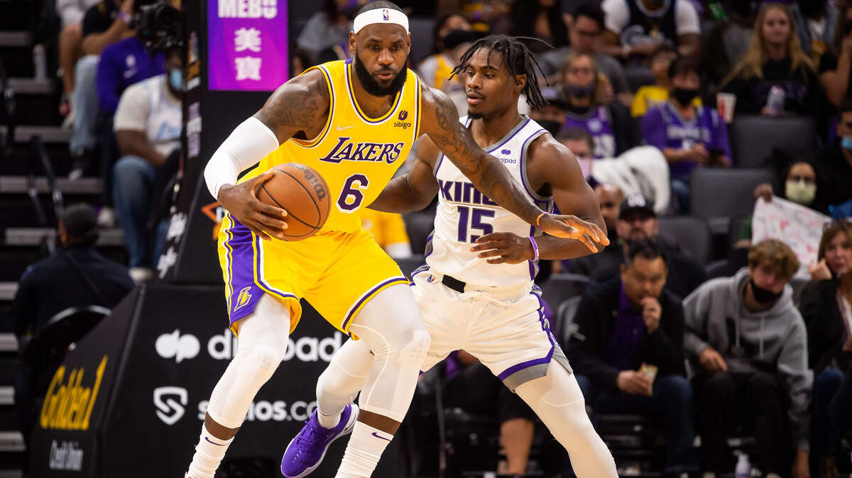Sacramento Kings guard Davion Mitchell (15), right, defends against Los Angeles Lakers forward LeBron James (6) during the first half of their final preseason NBA basketball game Thursday, Oct. 14, 2021, at Golden 1 Center in downtown Sacramento.