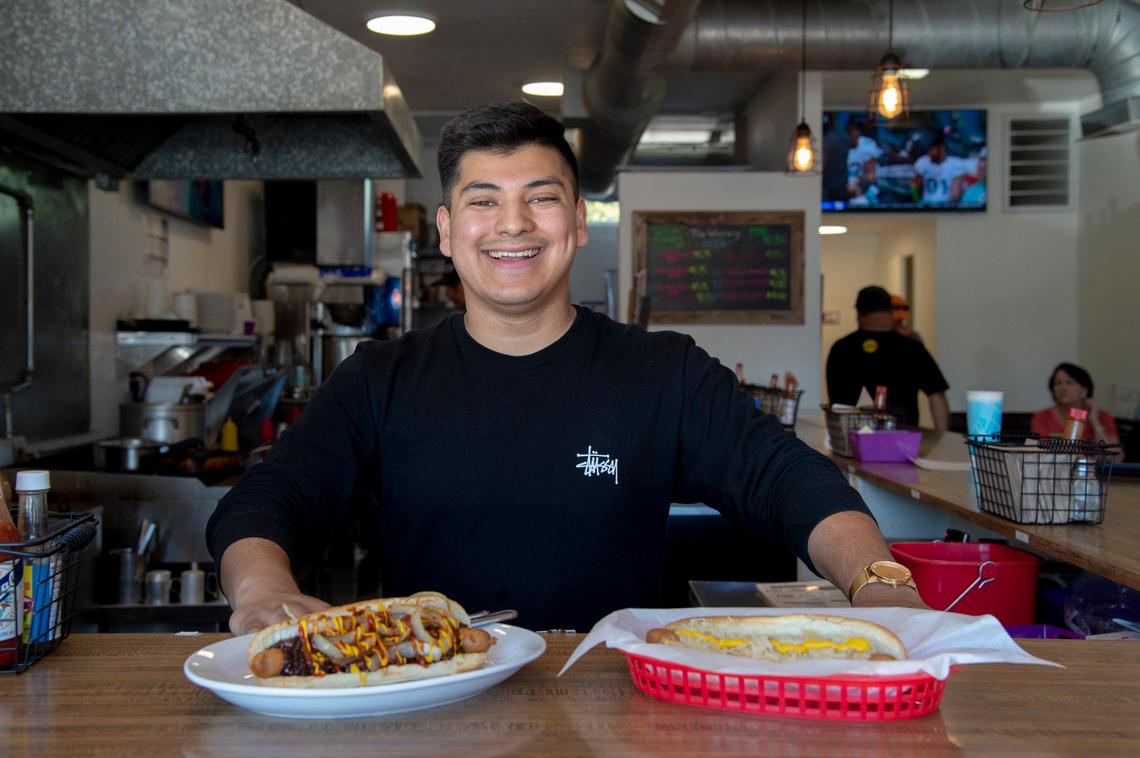 Arnie Jacobo, manager of The Wienery, shows off a Kraut Dog and The Joey on Monday, May 14, 2018.