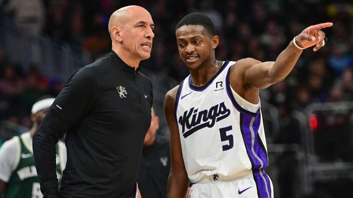 Jan 14, 2025; Milwaukee, Wisconsin, USA; Sacramento Kings guard De'Aaron Fox (5) talks to interim head coach Doug Christie in the second quarter against the Milwaukee Bucks at Fiserv Forum. Mandatory Credit: Benny Sieu-Imagn Images