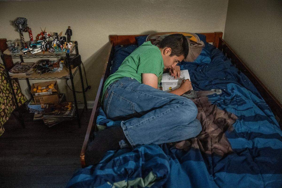 Max Moran Soto, 14, spends uses his tablet in his bedroom in Manteca on Aug. 24. He loves watching Spongebob Squarepants.