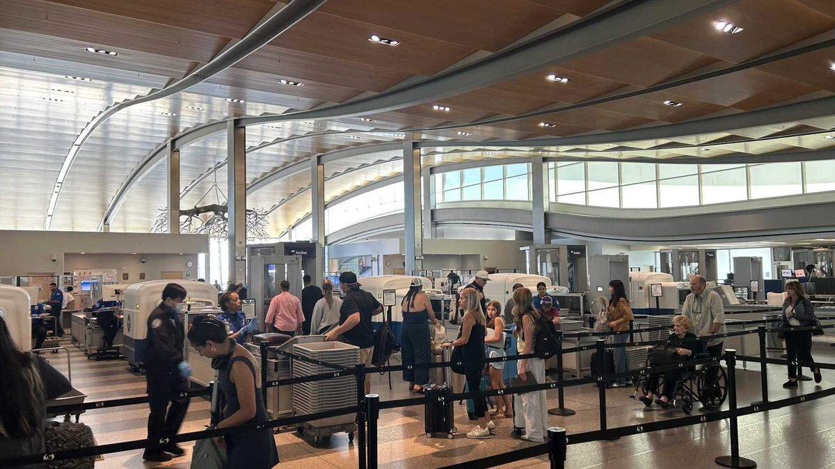 Travelers pass through the Terminal B security checkpoint at Sacramento International Airport on July 8, 2025.