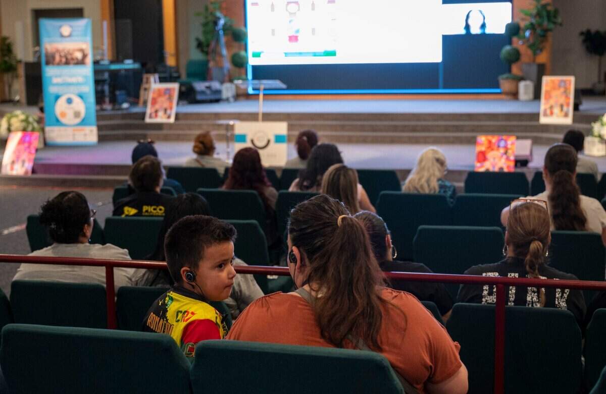 Olga Flores and her son Isaac, 7, a Sacramento City Unified School District student, attend a Sacramento ACT town hall meeting focused on community schools at South Sacramento Christian Center on April 12.