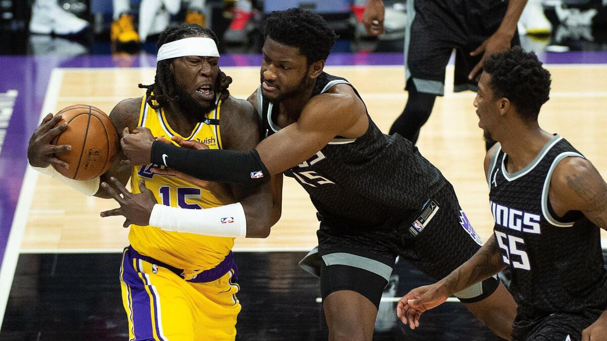 Los Angeles Lakers center Montrezl Harrell (15) battles Sacramento Kings forward Chimezie Metu (25) in the first quarter during a game at Golden 1 Center on Friday, April 2, 2021 in Sacramento.