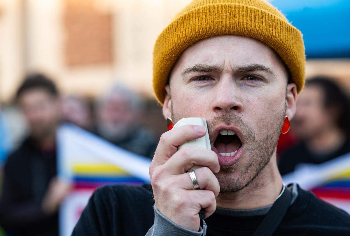 Eric Nelson leads protesters in a chant during a demonstration in Sacramento on Saturday against U.S. military action in Venezuela after President Donald Trump announced a bombing raid on the country and the capture of its leader. 