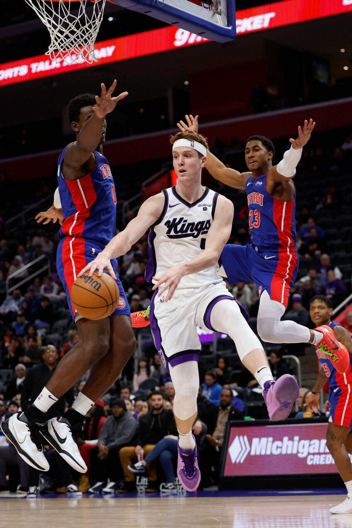 Sacramento Kings guard Kevin Huerter (9) passes on Detroit Pistons center Jalen Duren (0) and guard Jaden Ivey (23) in the first half Tuesday, Jan. 9, 2024, at Little Caesars Arena in Detroit, Michigan.