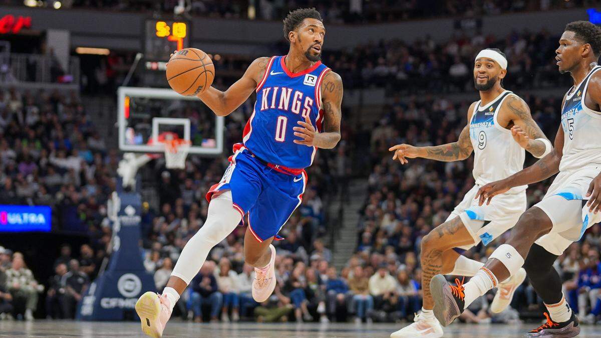 Nov 27, 2024; Minneapolis, Minnesota, USA; Sacramento Kings guard Malik Monk (0) dribbles against the Minnesota Timberwolves in the third quarter at Target Center. Mandatory Credit: Brad Rempel-Imagn Images