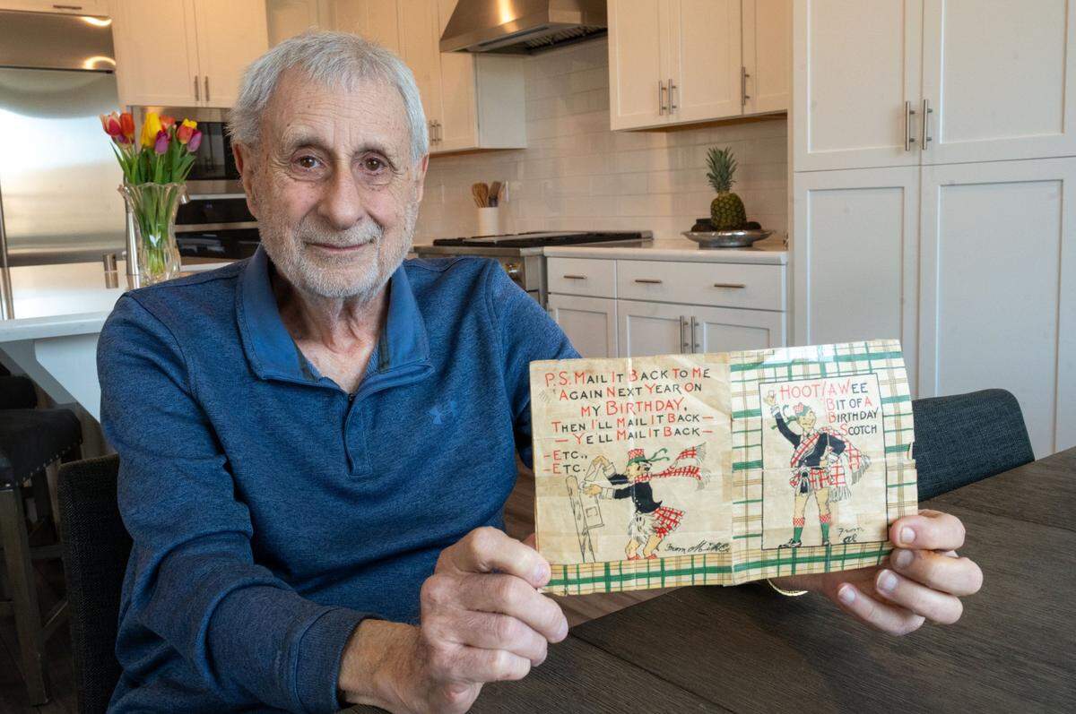 Sacramento resident Tom Rose holds the birthday card earlier this month that has been sent back and forth between family members since 1936. The tradition started with his father and his uncle, and their sons have kept it going.