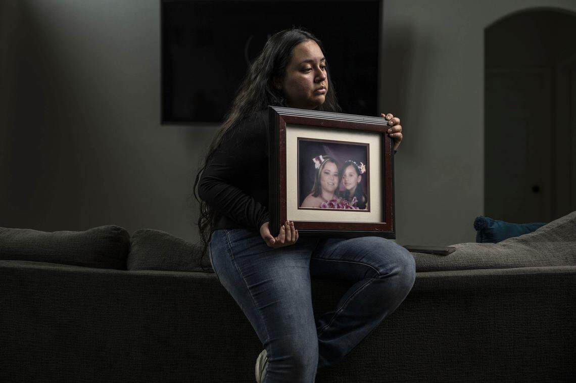 Sacramento resident Damaris Bello, 22, holds a picture of herself with her mother Maria de Jesus Estrada Juarez, who was deported to Mexico after appearing for a green card hearing at the John Moss Federal Building in Sacramento.