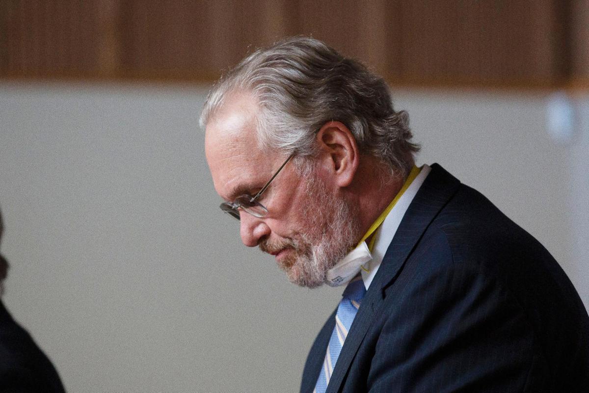 Bill Johnson, chief executive officer and president of PG&E Corp., lowers his head after admitting the company’s guilt in the deaths of 84 people in a 2018 wildfire, during a hearing in Butte County Superior Court in Chico, Calif., Tuesday, June 16, 2020. Johnson entered guilty pleas on behalf of the company for 84 felony counts of involuntary manslaughter stemming from the fire which was blamed on the company’s crumbling electrical grid the wiped out the town of Paradise in November of 2018.(AP Photo/Rich Pedroncelli, Pool)