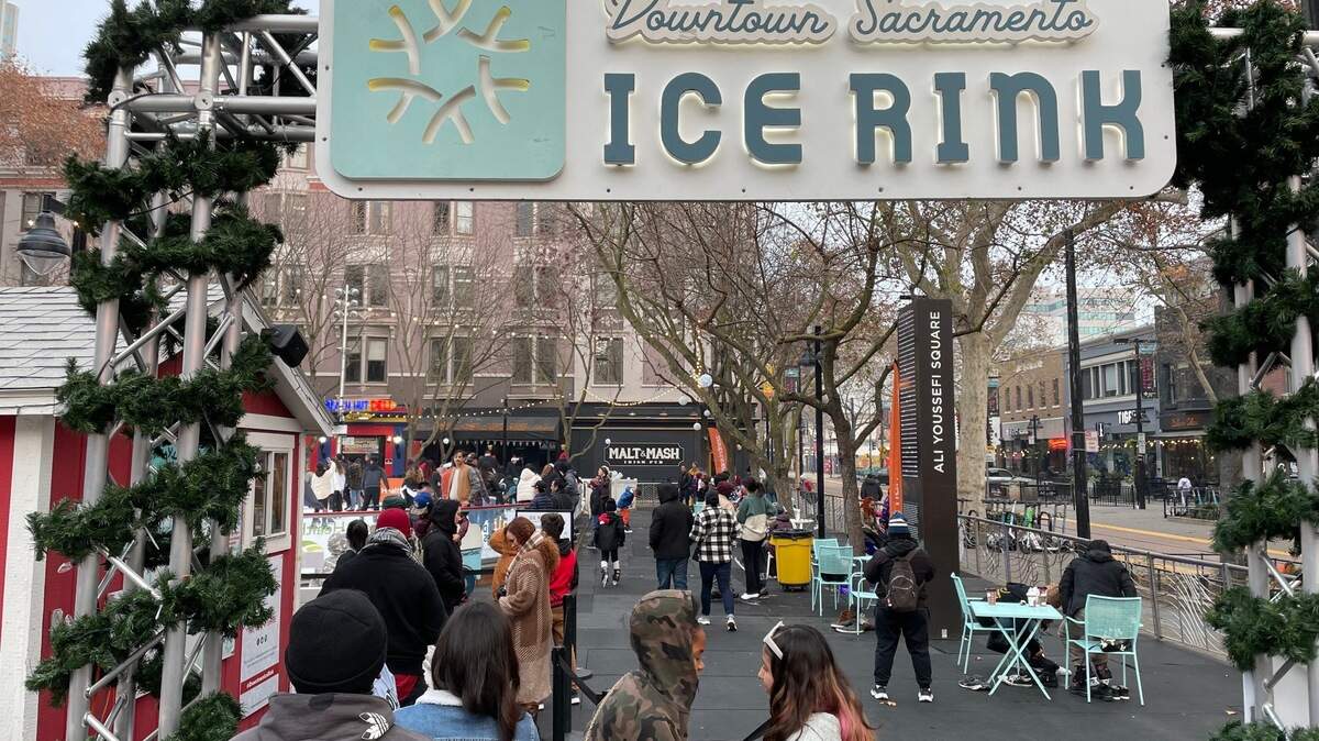 Service Journalism reporter Brianna Taylor visits Downtown Sacramento Ice Rink at 701 K St., Sacramento on Sunday, Dec. 18, 2022. The line to get into the family-friendly rink is wrapped around the entrance on a chilly winter afternoon.