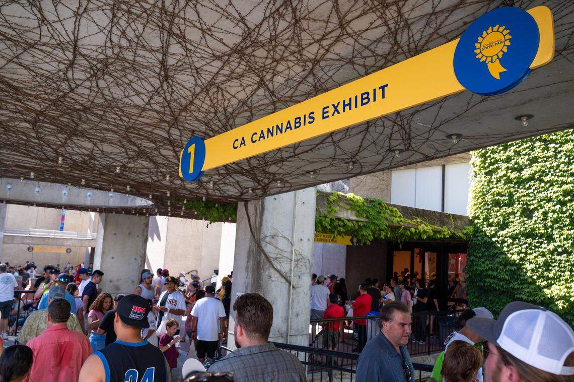 People walk outside the California State Fair’s inaugural Cannabis Awards exhibit Saturday at Cal Expo. Visitors wanting to enter the cannabis exhibit must be 21 or older.