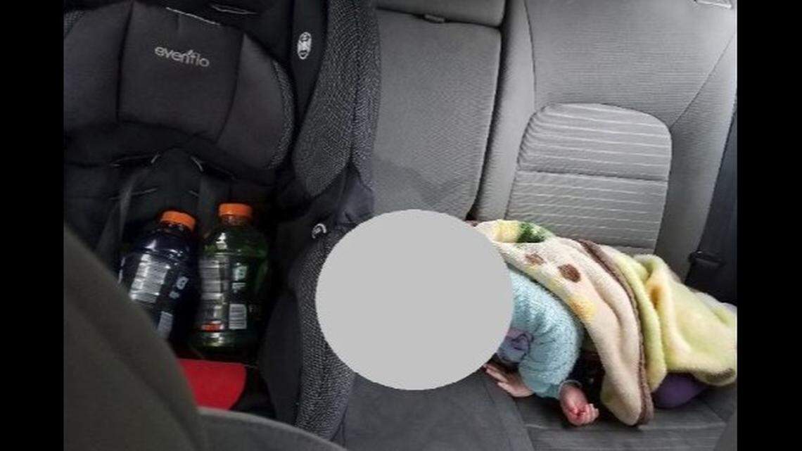 A Twitter post by Redmond, Washington, police shows a baby asleep next to a child car seat carrying Gatorade bottles. Officers say the driver was stopped going 80 mph.