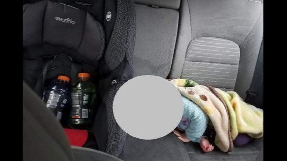 A Twitter post by Redmond, Washington, police shows a baby asleep next to a child car seat carrying Gatorade bottles. Officers say the driver was stopped going 80 mph.