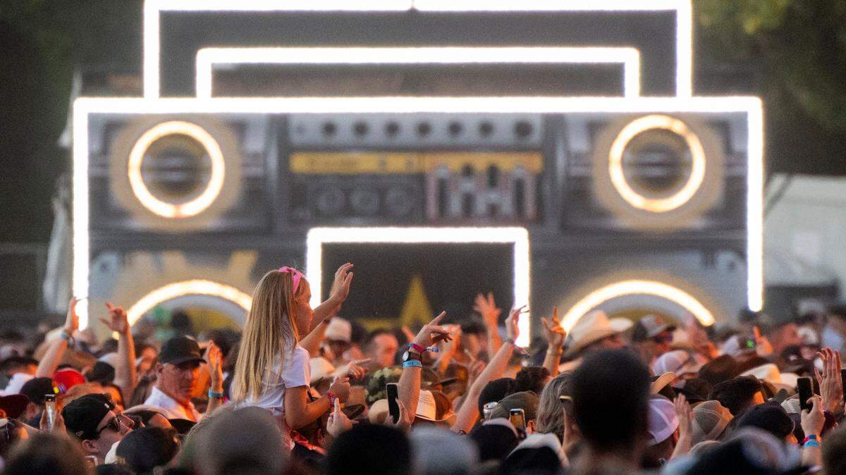 Concert fans watch a performance in front of a giant boombox art installation at the GoldenSky Festival in Sacramento’s Discovery Park. New legislation would stop deceptive ticket resale practices.
