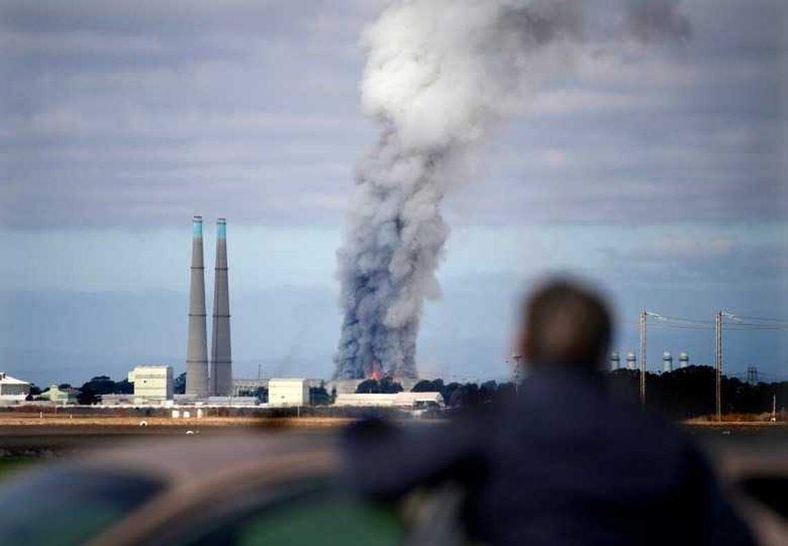A bystander watches the smoke and flames from Castroville as a fire at the Vistra battery storage plant burns in Moss Landing on Friday, Jan. 17, 2025.