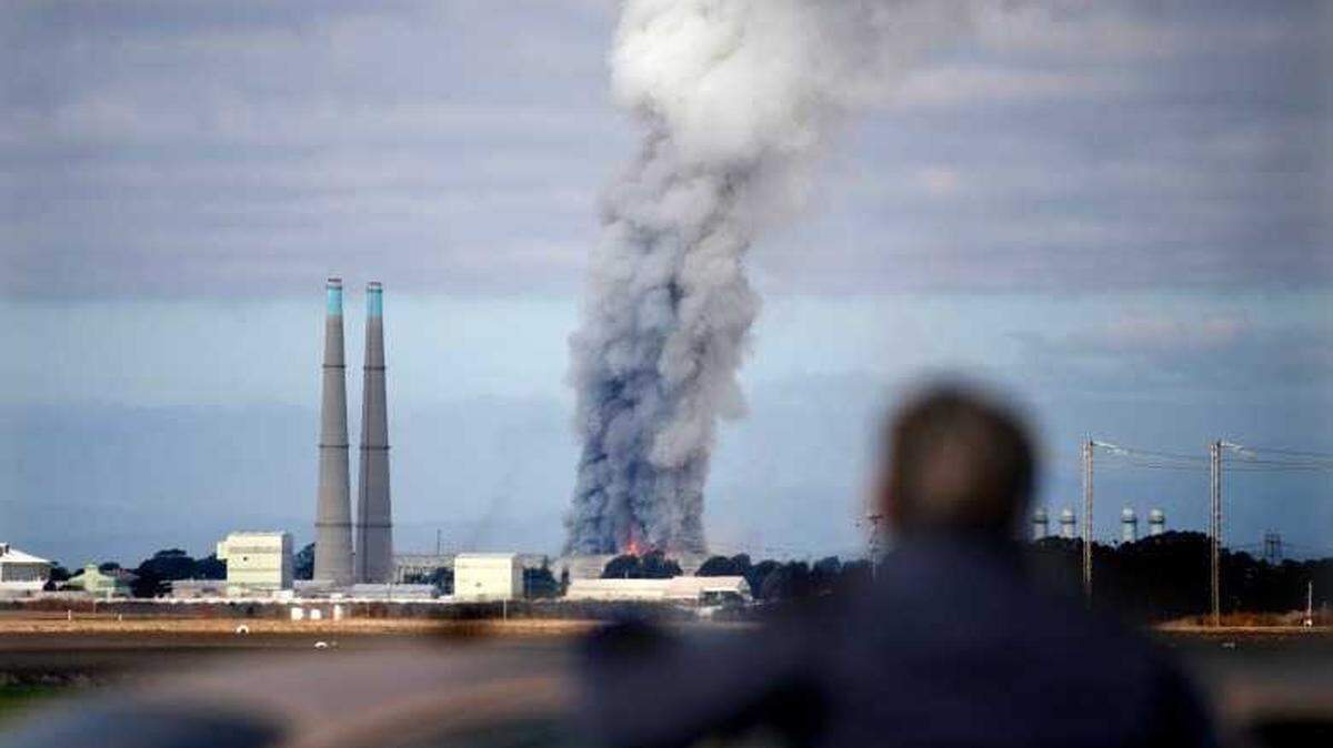 A bystander watches the smoke and flames from Castroville as a fire at the Vistra battery storage plant burns in Moss Landing on Friday, Jan. 17, 2025.