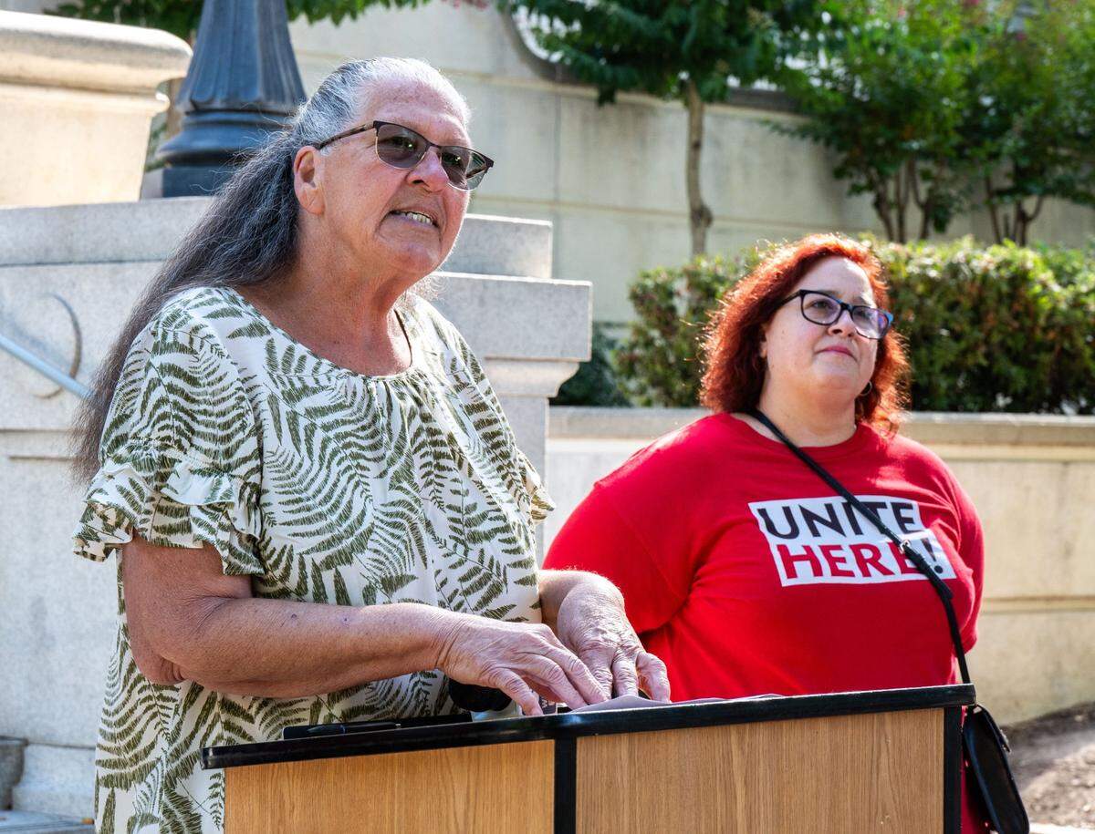 Railyards resident Nancy Williams, left, speaks at a Thursday news conference at Sacramento City Hall accusing the city of Sacramento of delaying counting the votes of residents in the Railyards financing district.